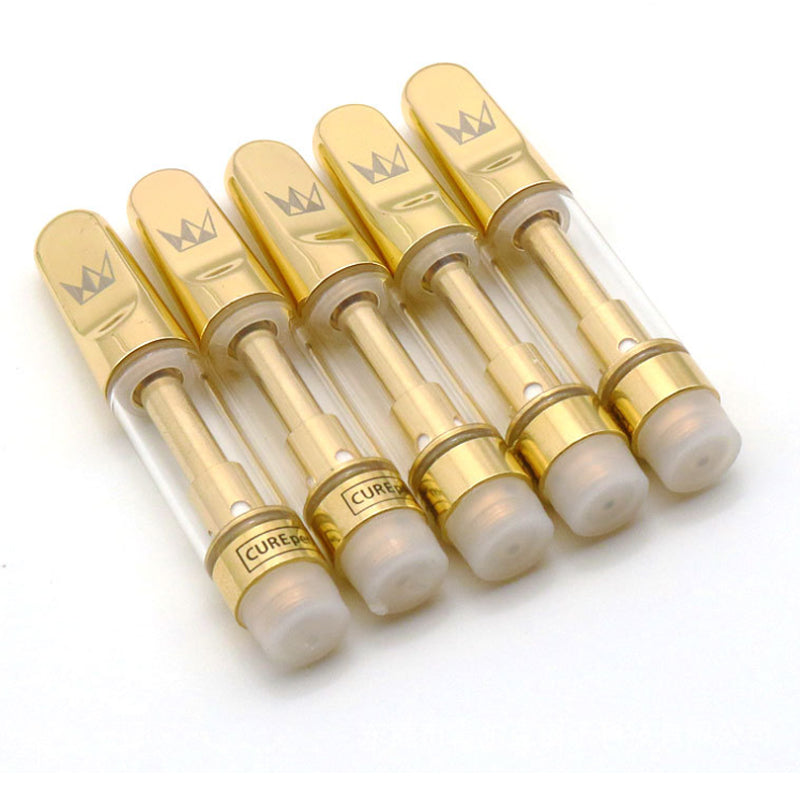 Set of gold and clear vape cartridges with 'Cured' branding on a white background