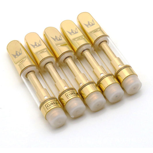 Set of gold and clear vape cartridges with 'Cured' branding on a white background