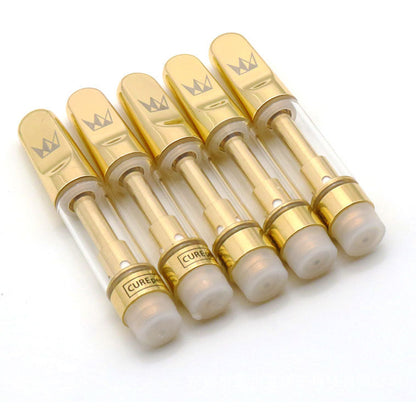 Set of gold and clear vape cartridges with 'Cured' branding on a white background